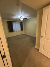 Empty room featuring carpet and a textured ceiling