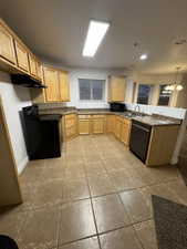 Kitchen featuring light brown cabinets, sink, an inviting chandelier, decorative light fixtures, and black appliances