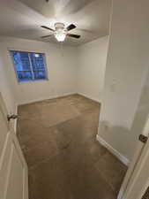 Unfurnished room featuring carpet, a textured ceiling, and ceiling fan