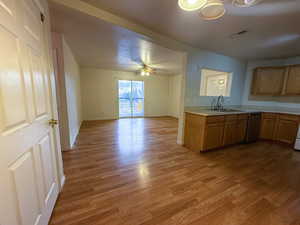 Kitchen featuring light hardwood / wood-style floors, sink, a textured ceiling, and ceiling fan