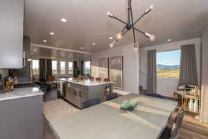 Model home picDining room featuring hardwood / wood-style flooring, a mountain view, sink, and a wealth of natural light