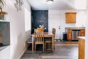 Dining space with dark hardwood / wood-style floors and sink