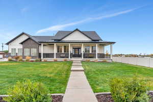 View of front of property with a front yard and a porch