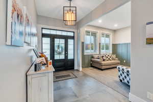 Foyer entrance with a notable chandelier