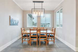 Dining room featuring a chandelier and ornamental molding