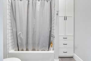 Bathroom featuring shower / tub combo with curtain