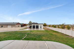 Back of house featuring a yard and a patio