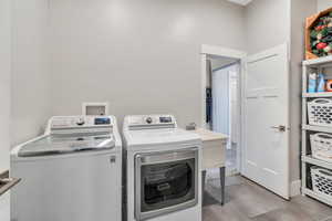 Clothes washing area featuring independent washer and dryer