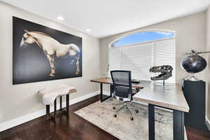 Home office featuring dark hardwood / wood-style floors