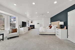 Carpeted bedroom featuring ceiling fan