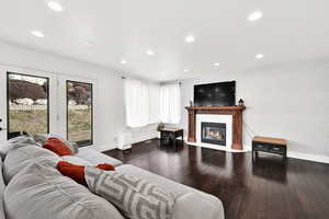 Living room with dark hardwood / wood-style floors