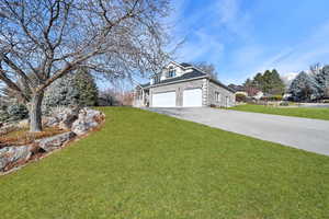 Exterior space featuring a front lawn and a garage