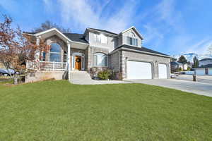 View of front of home with a garage and a front yard