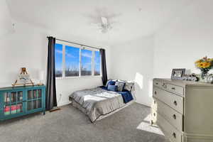 Bedroom with ceiling fan and light colored carpet