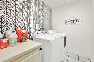 Laundry room with light tile patterned floors