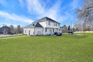 Back of house featuring a patio and a lawn