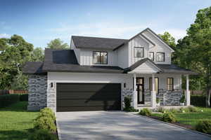 View of front of property featuring a front lawn, covered porch, and a garage