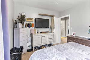 Bedroom with light carpet and a textured ceiling