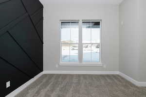 Unfurnished room with carpet floors