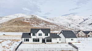 Snow covered property featuring a mountain view