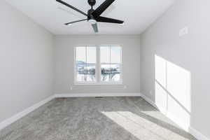 Empty room with carpet floors and ceiling fan