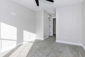 Unfurnished room featuring ceiling fan and light colored carpet