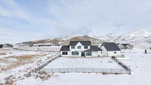 Snow covered house with a mountain view