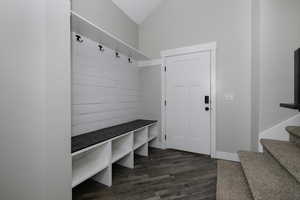 Mudroom featuring dark hardwood / wood-style flooring and vaulted ceiling