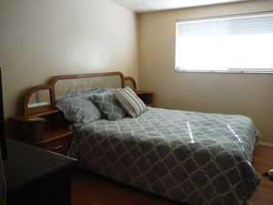 Bedroom featuring dark hardwood / wood-style flooring