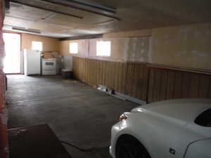 Garage featuring white refrigerator