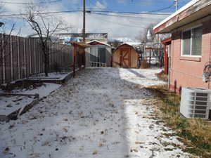 Snowy yard with a storage unit and cooling unit