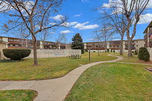 View of property's community with a yard