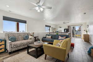 Basement Living room with a wealth of natural light and ceiling fan.