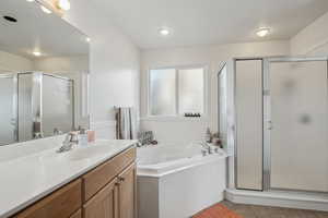 Master Bathroom with  walk in shower, vanity, and tile patterned floors