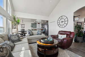 Living room with LVP floors and high vaulted ceiling