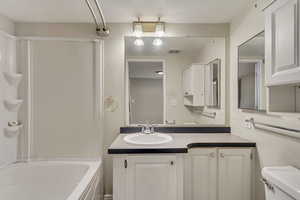 Full bathroom with shower / washtub combination, vanity, and toilet