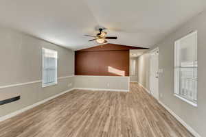 Spare room with ceiling fan, light hardwood / wood-style flooring, and lofted ceiling