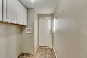 Laundry area with cabinets and hookup for a washing machine