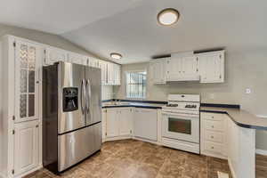 Kitchen with sink, white cabinets, and white appliances