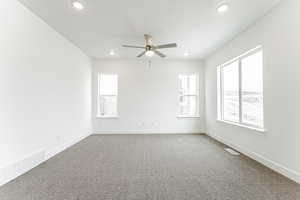 Spare room featuring recessed lighting, a ceiling fan, visible vents, and carpet