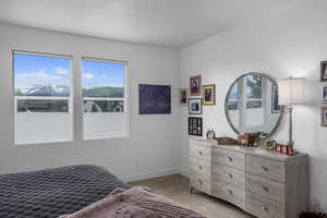 Bedroom featuring a mountain view and light colored carpet