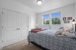 Bedroom with carpet and a closet