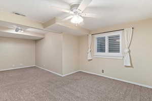 Spare room featuring ceiling fan and carpet