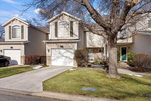 Front facade with a garage and a front yard