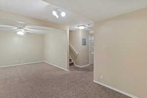 Basement featuring carpet, ceiling fan, and electric panel