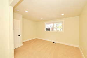 Carpeted empty room with a textured ceiling