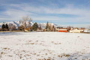 Snowy yard featuring a mountain view