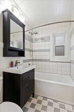 Full bathroom with vanity, toilet, tiled shower / bath, and wooden ceiling