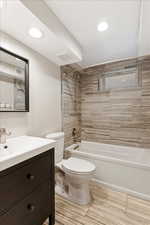 Full bathroom with vanity, toilet, and tiled shower / bath