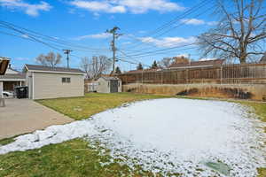 Yard with a shed and a patio